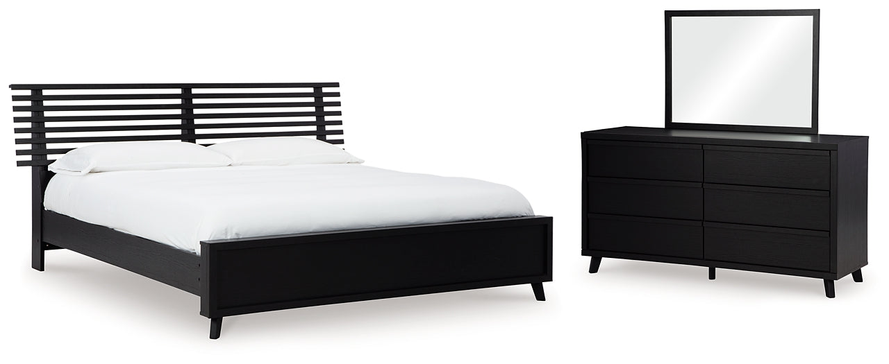 Danziar King Panel Bed with Mirrored Dresser